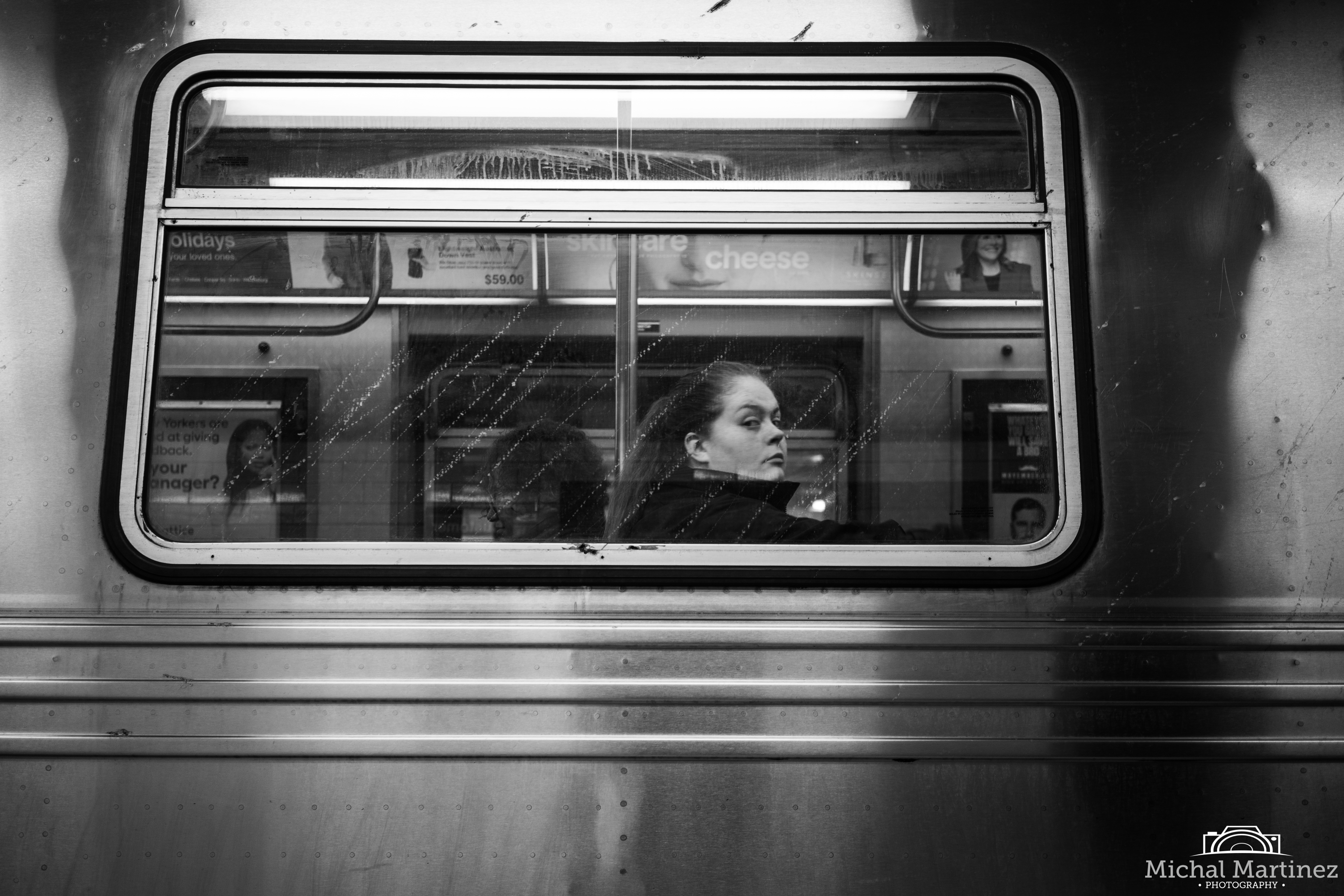 Woman in subway car - 3/4 profile looking at camera